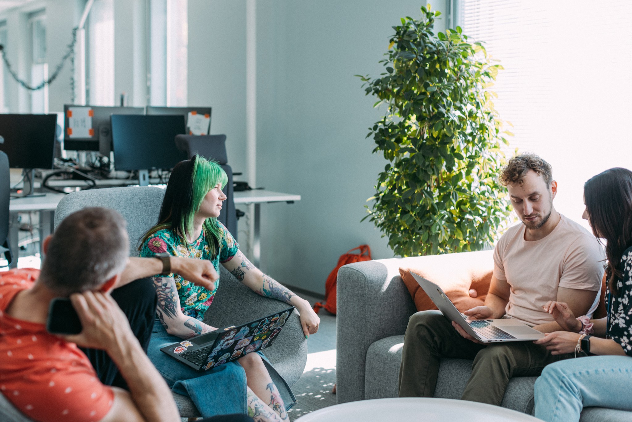 Team sitting around a table in sofas and chairs